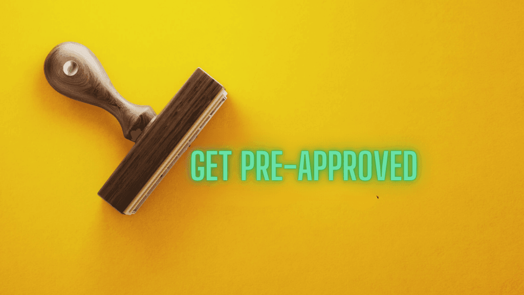 Rubber stamp on a yellow background with text 'Get Pre-Approved' in turquoise letters.