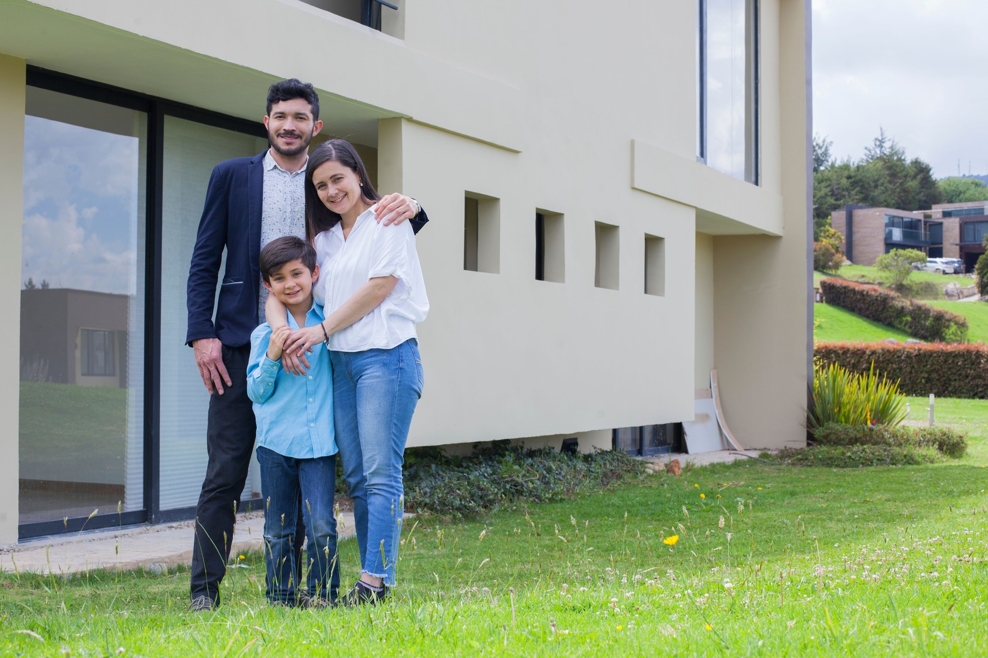 Happy family outside their new house