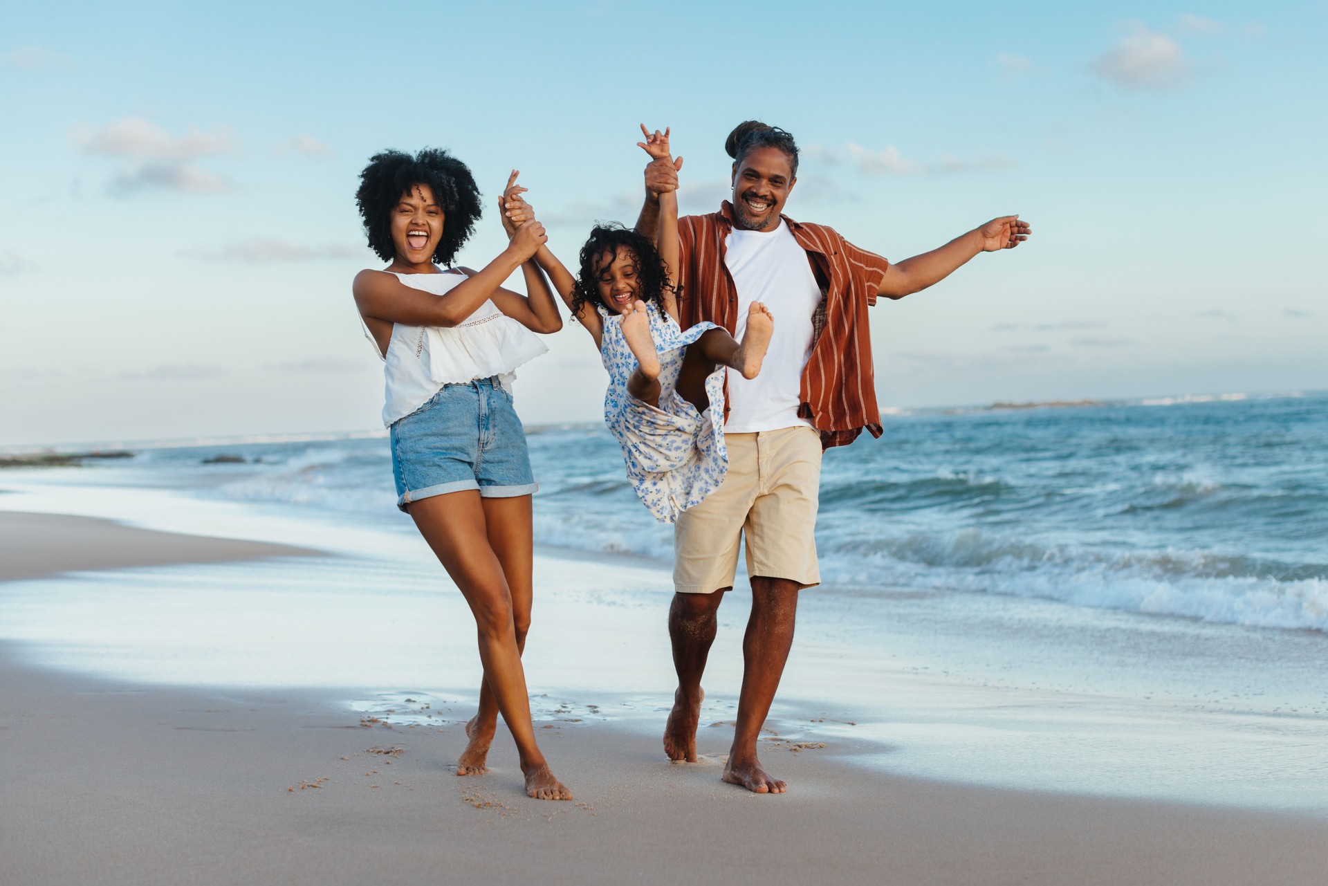 Happy family enjoying vacation on the beach together