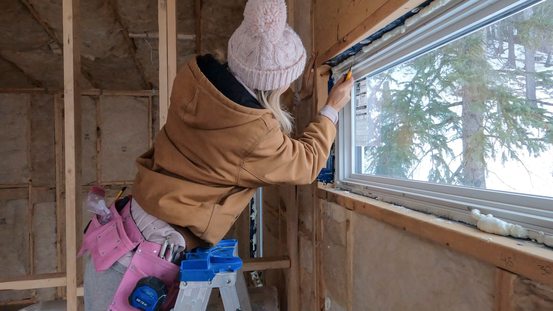 Young woman works on home construction