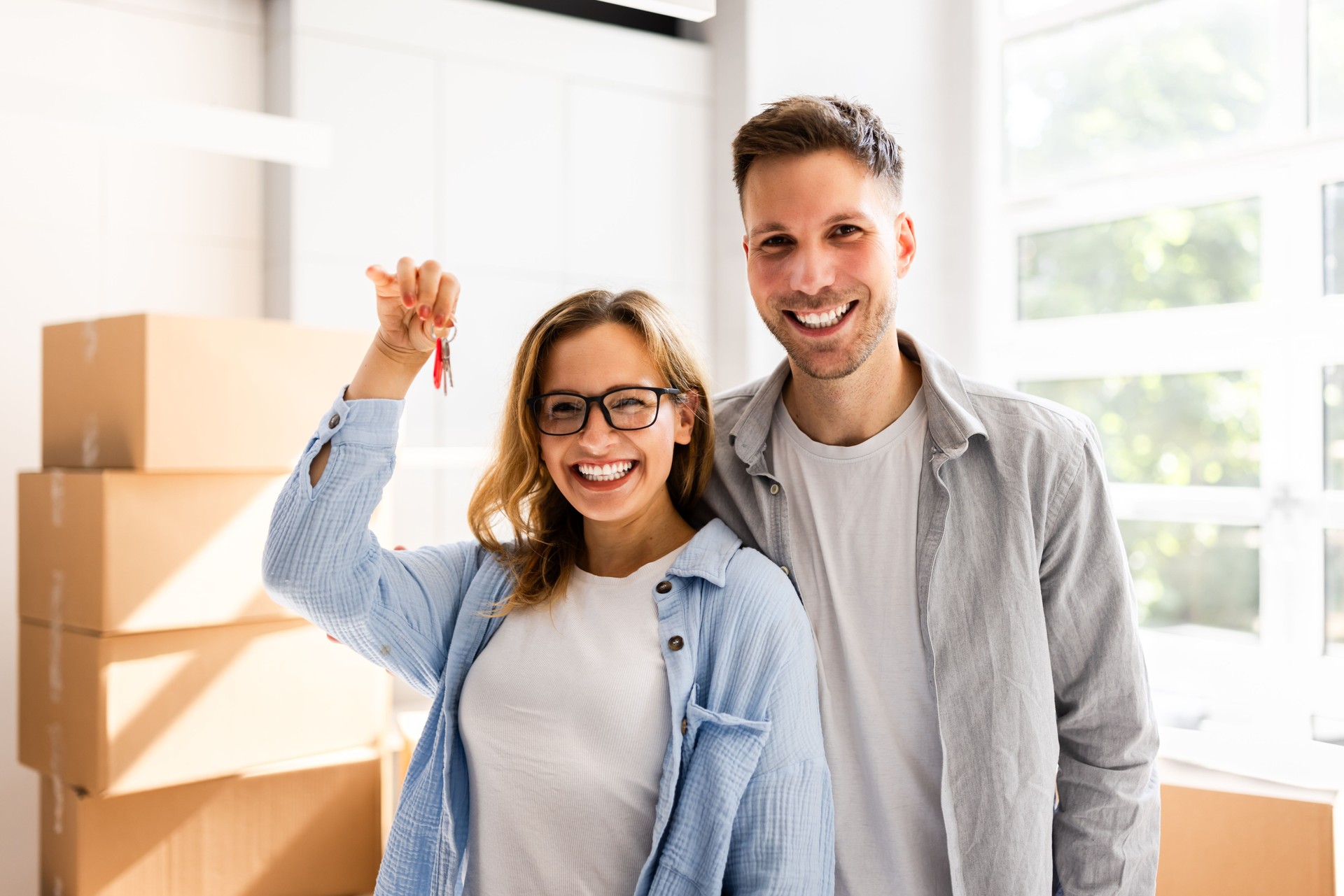 Happy Couple Moving Into New House Or Home Holding Keys