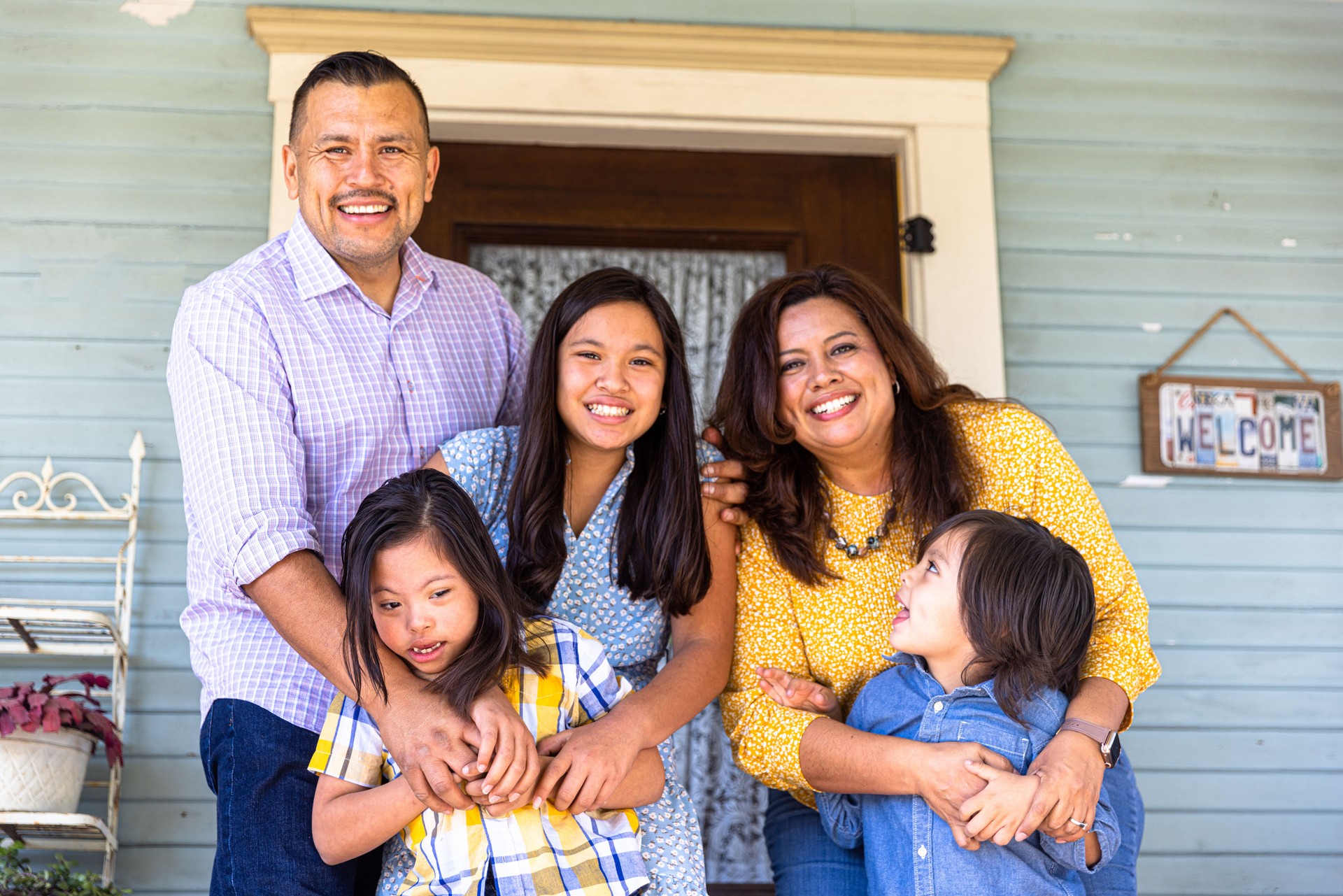 Mexican Family together in front of home