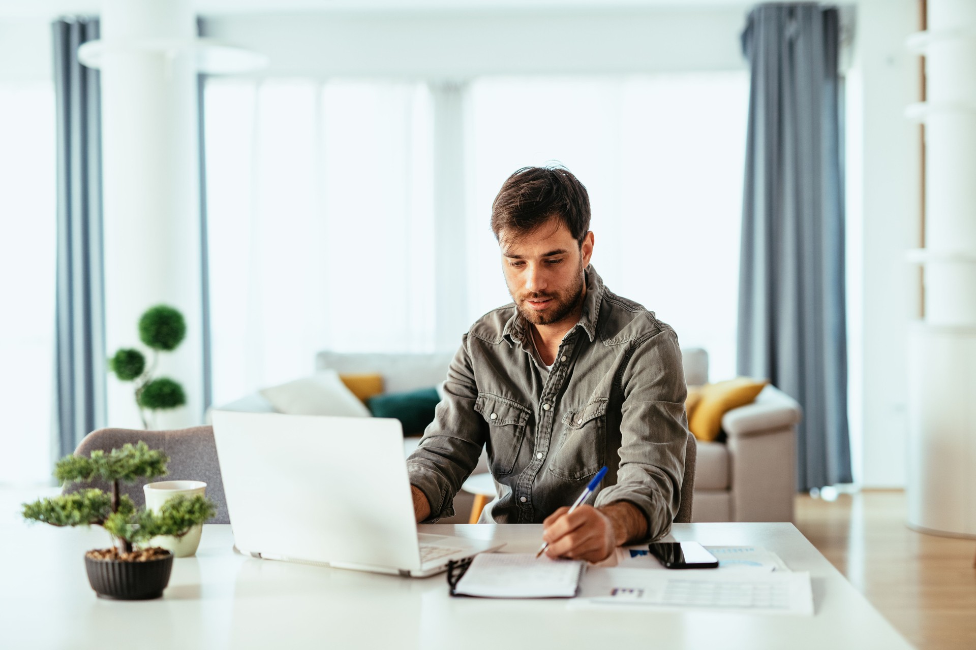 Portrait of person working in modern office on laptop