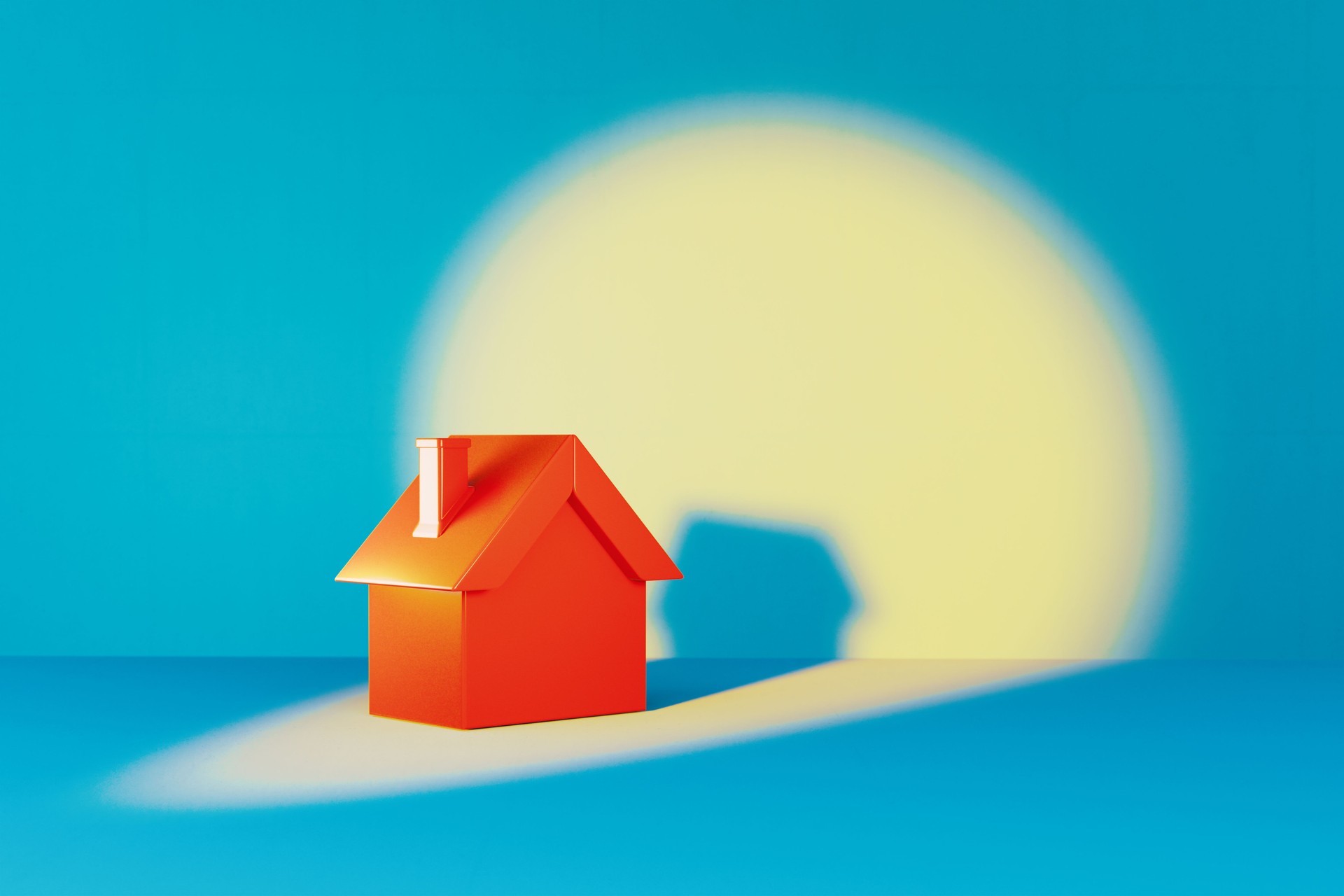 Coral Colored House Object Under Spotlight On Blue Background