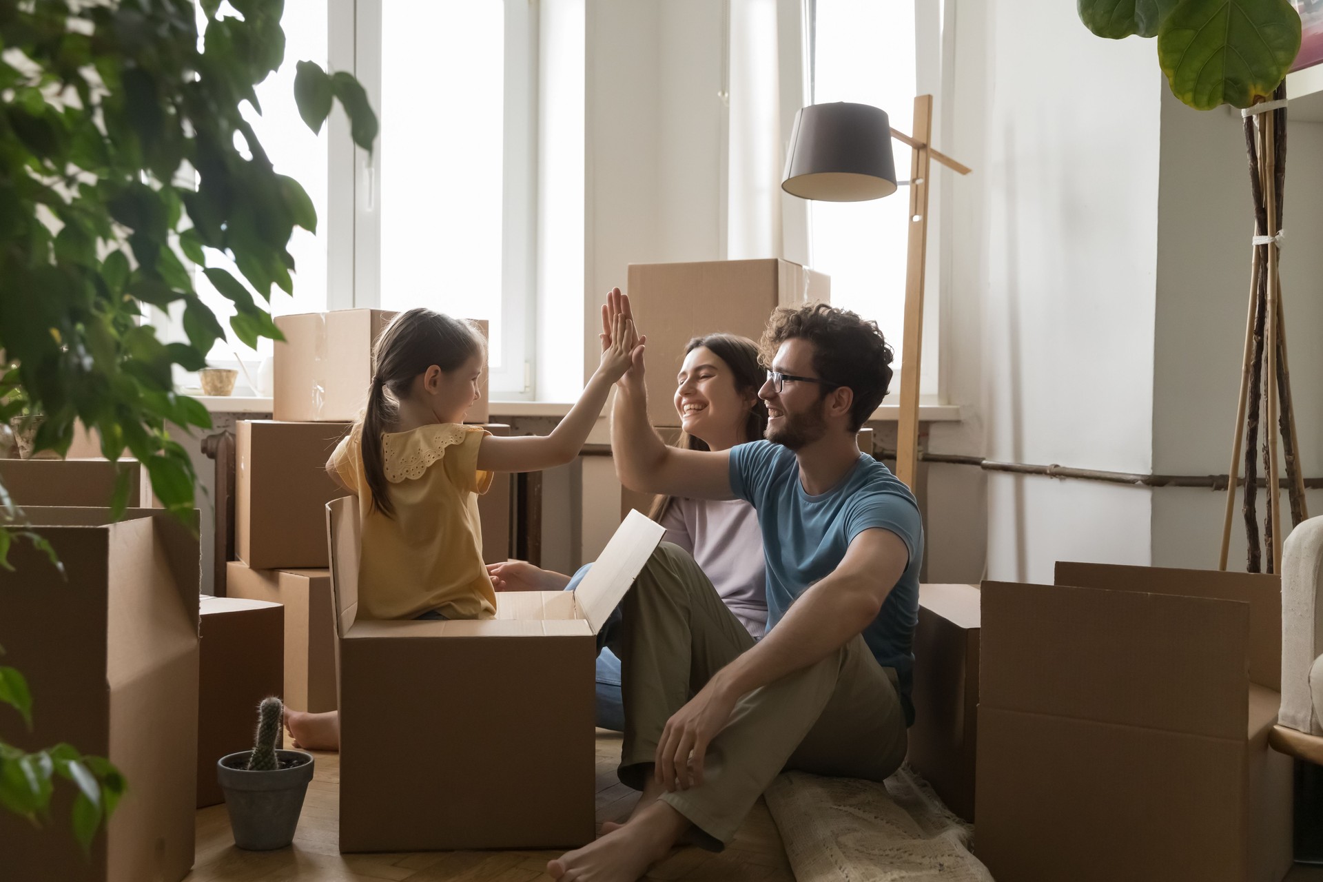 Family with little daughter celebrate relocation day